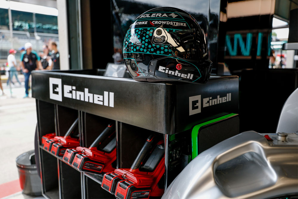 Herramientas inalámbricas Einhell en un carrito, con un casco de carreras encima